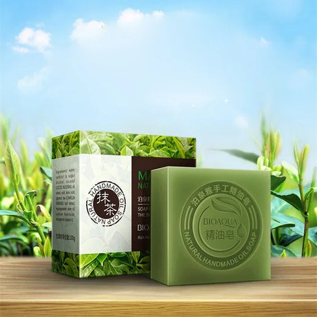 Green soap bar and packaging on a wooden surface with a natural background