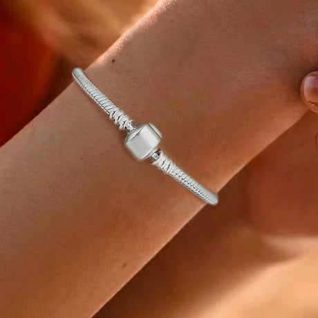 Silver bracelet on a wrist with a blurred background