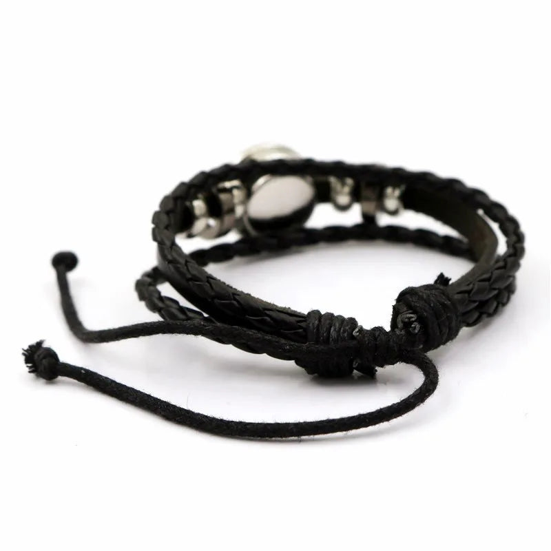 Black braided bracelet with metal clasp on a white background