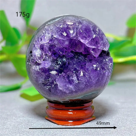 Amethyst crystal sphere on a stand with measurements and weight displayed
