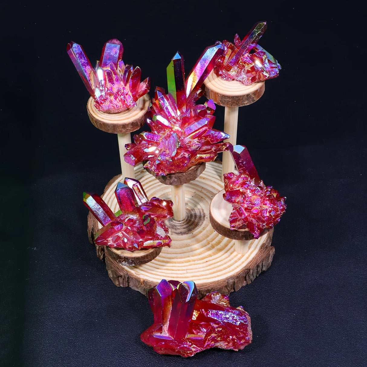 Decorative crystal display on a wooden stand against a black background