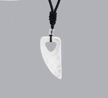White pendant on a black cord against a gray background