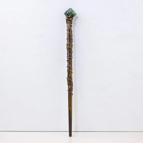 Decorative staff with a green stone top on a white background