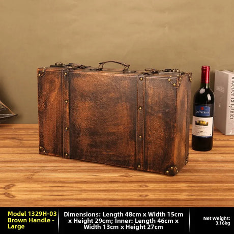 Vintage-style brown suitcase on a wooden surface with a bottle of wine and a book in the background.