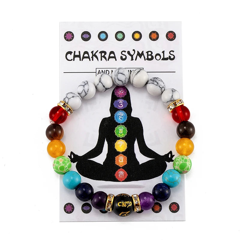 Chakra symbol bracelet on a card with colorful beads and black silhouette of a meditating person.