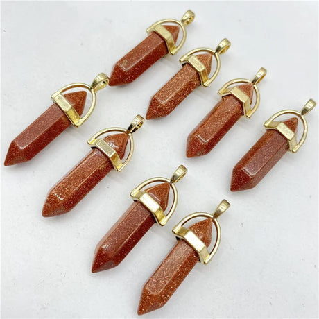Goldstone pendants with gold accents on a white background