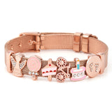 Rose gold dog collar with various charms on a white background