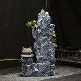 Decorative rock formation with a small pagoda and trees on a dark background