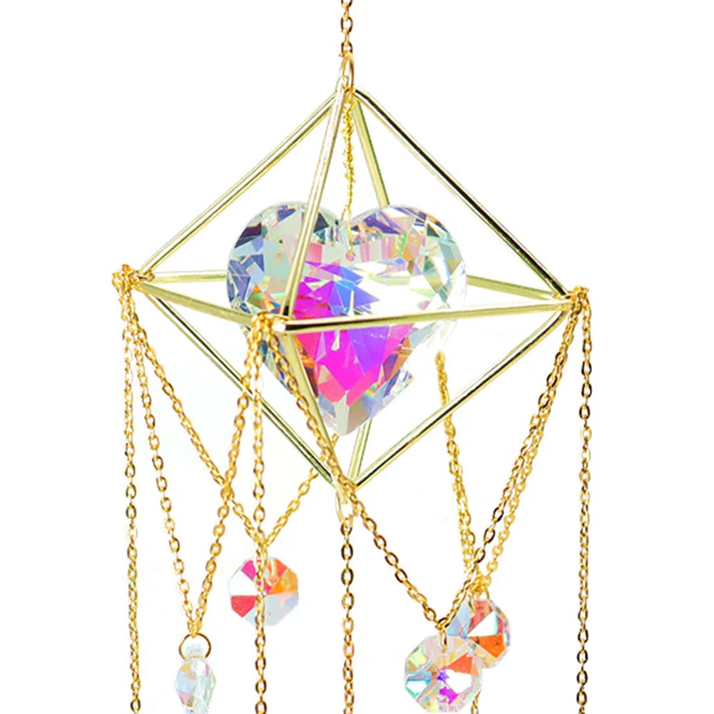 Decorative hanging crystal with gold frame and chains on a white background