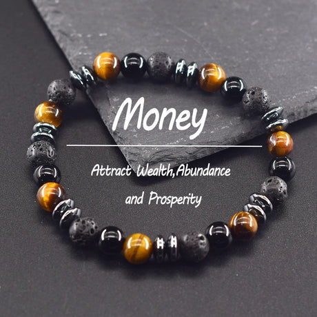 Beaded bracelet with black, orange, and gray beads on a dark surface with 'Money' text.