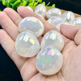 Opal stones held in a hand with blurred background