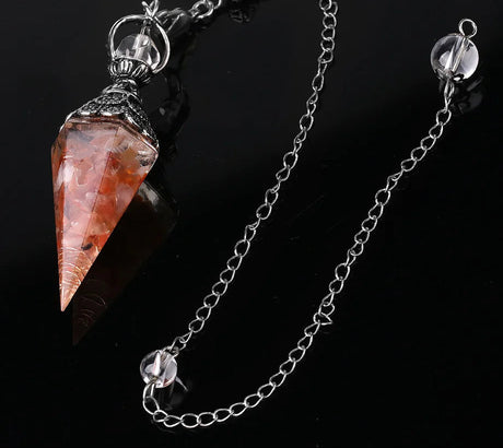 Crystal pendant on a chain with a dark background