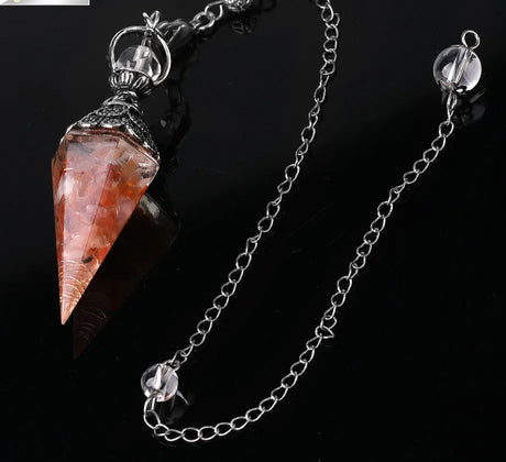 Crystal pendant on a chain with a dark background