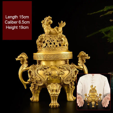 Gold incense burner with intricate designs on a dark background