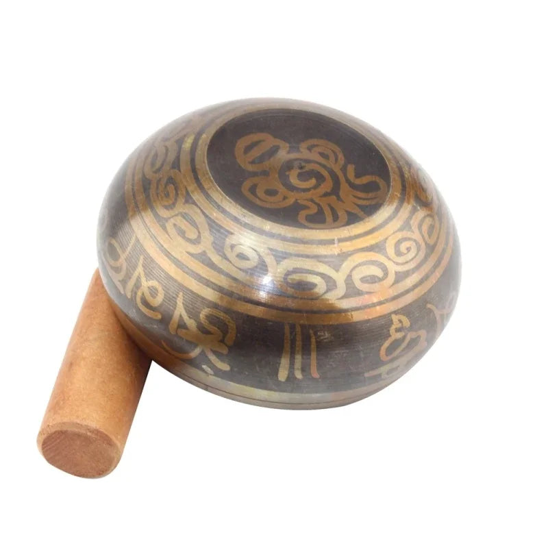 Tibetan singing bowl with decorative patterns on a white background
