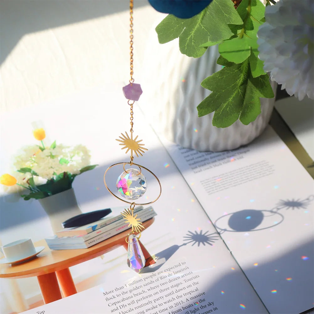 Decorative crystal hanging ornament on an open book with flowers in the background