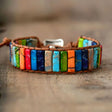 Colorful beaded bracelet on a wooden surface with a blurred background
