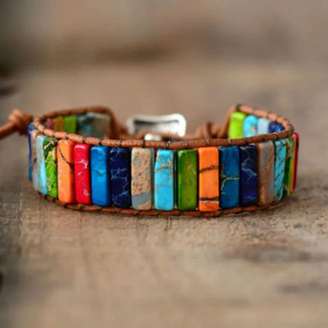 Colorful beaded bracelet on a wooden surface with a blurred background