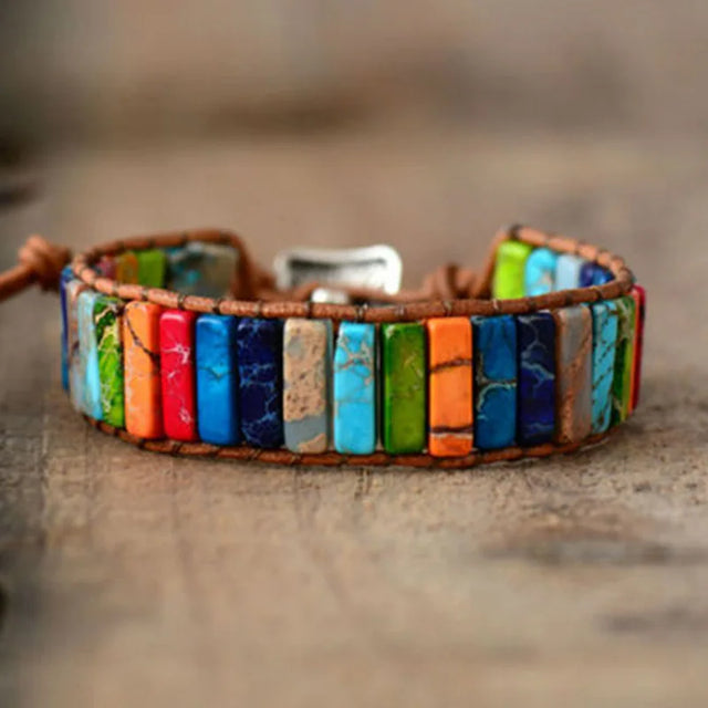 Colorful beaded bracelet on a wooden surface with a blurred background