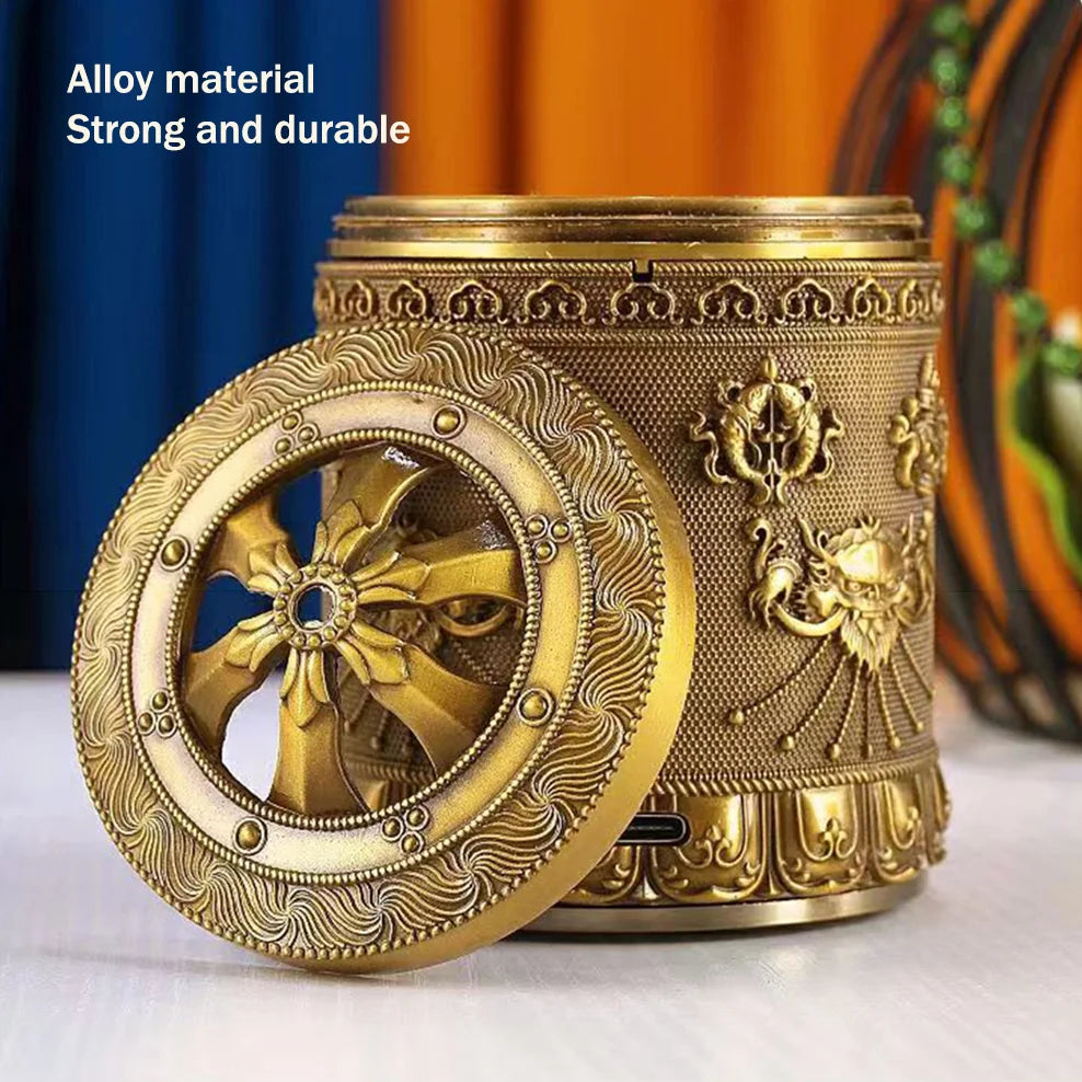 Decorative metallic container with intricate designs on a white surface