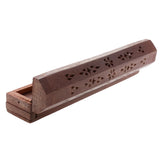 Wooden incense holder with floral patterns on a white background