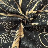Fabric with celestial pattern featuring stars and cosmic designs on a black background