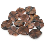 Collection of brown and black stone chips on a white background