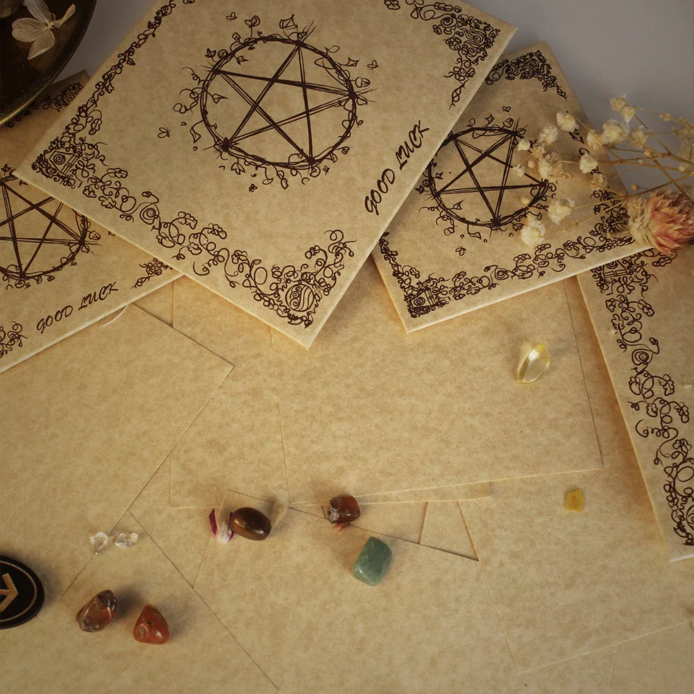 Parchment paper with pentacle designs and crystals on a textured surface