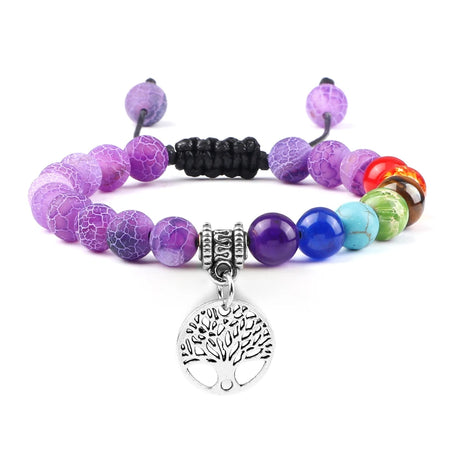 Multicolored beaded bracelet with a tree of life charm on a white background