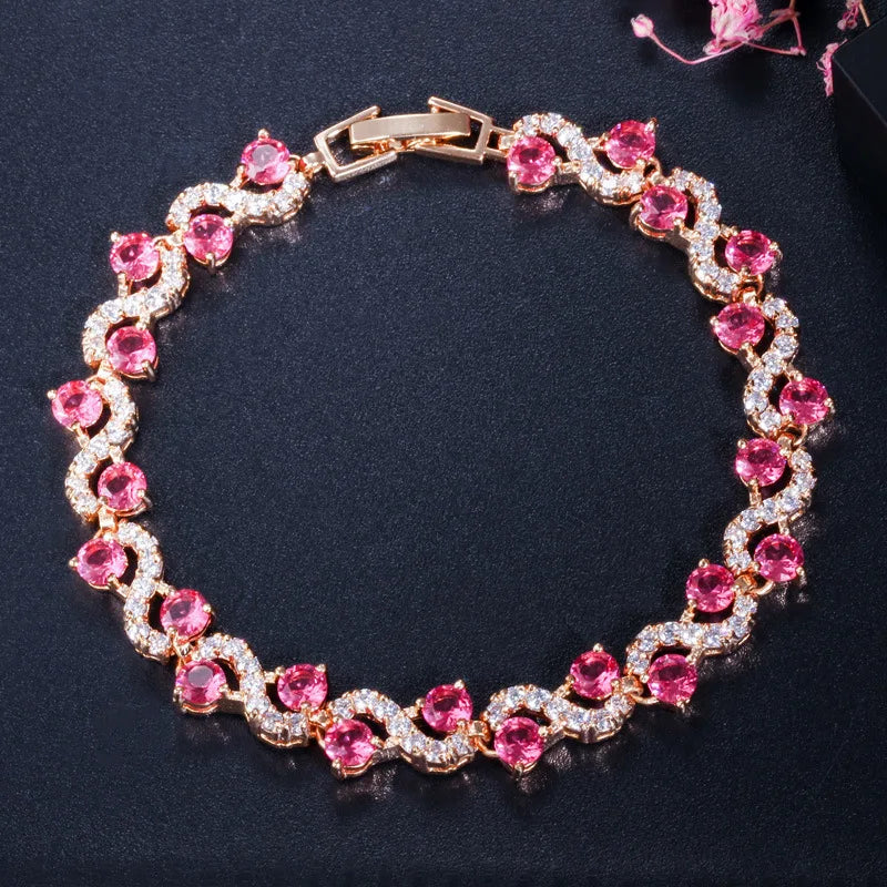 Bracelet with pink gemstones and gold accents on a dark background