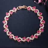 Bracelet with pink gemstones and gold accents on a dark background