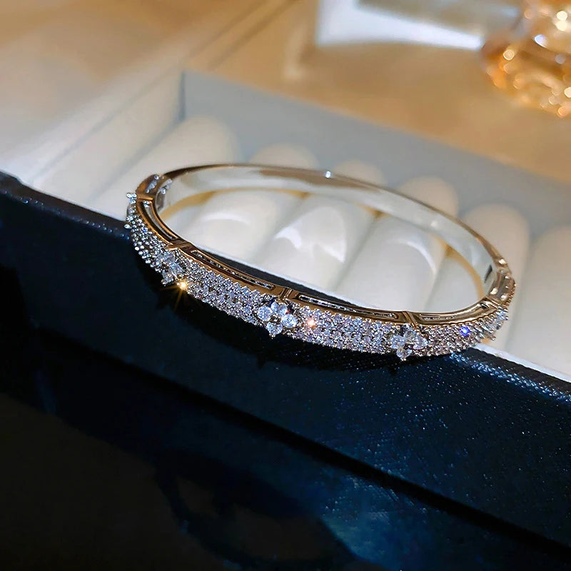 Gold bracelet with diamonds on a dark surface