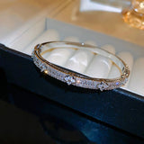 Gold bracelet with diamonds on a dark surface
