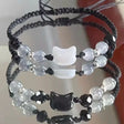 Two beaded bracelets with cat-shaped beads on a white background