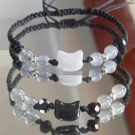 Two beaded bracelets with cat-shaped beads on a white background