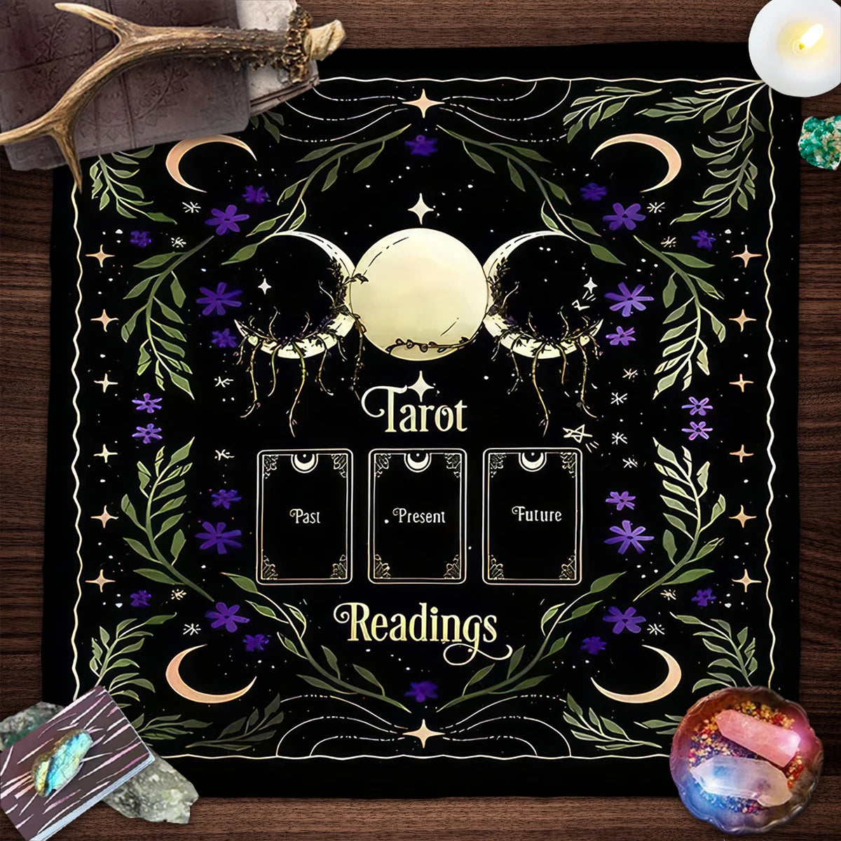Decorative mat with tarot design on a wooden surface with tarot cards and crystals.