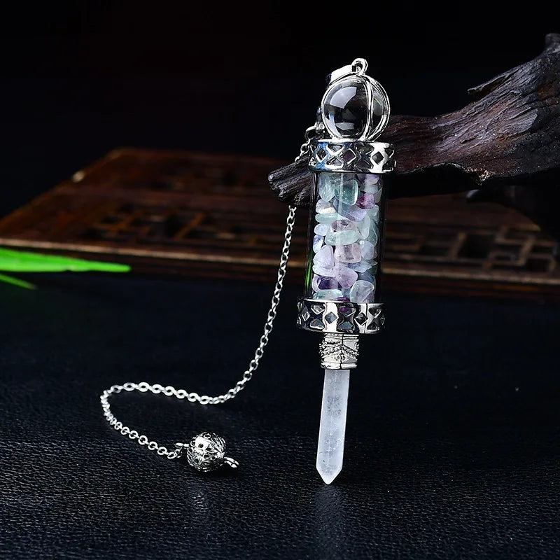 Crystal pendant with chain on a dark background