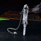 Crystal pendant with chain on a dark background