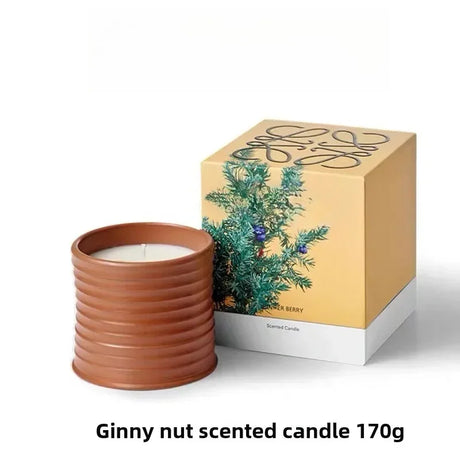 Ginny nut scented candle in a terracotta holder with packaging on a white background