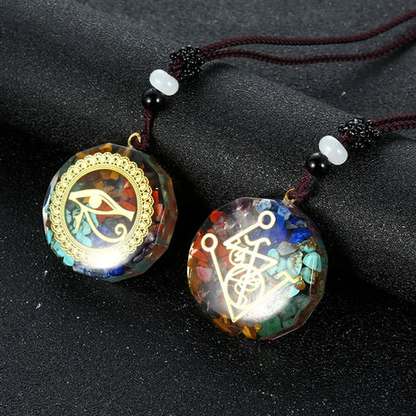 Two decorative pendants with intricate designs on a dark surface