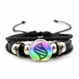 Black braided bracelet with a colorful circular charm on a white background