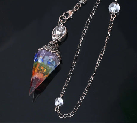 Colorful crystal pendant with chain on a dark background