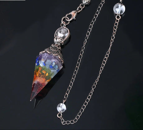 Colorful crystal pendant with chain on a dark background