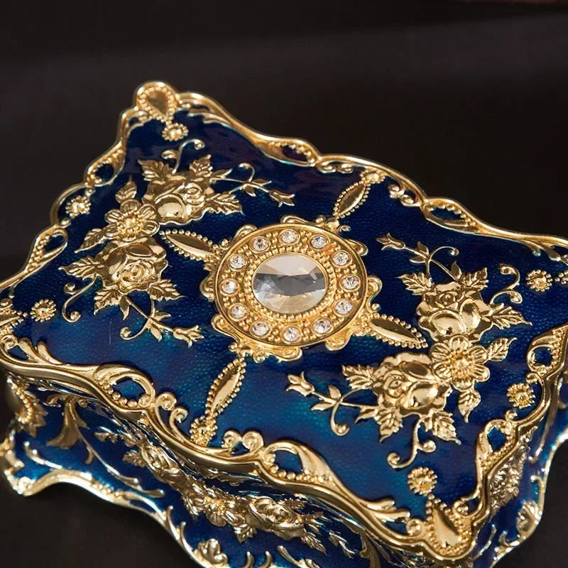 Decorative blue and gold object with intricate patterns on a dark background