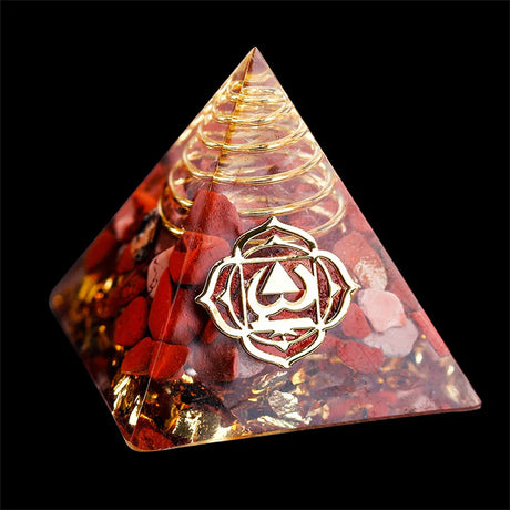 Pyramid-shaped crystal with a rose design and central symbol on a black background