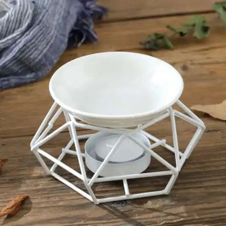 White geometric candle holder on a wooden surface