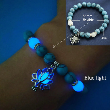 Turquoise beaded bracelet with lotus flower charm glowing blue on wrist against a dark background