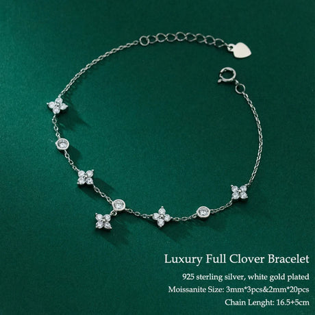 Silver bracelet with clover-shaped charms on a green background