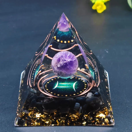 Crystal pyramid with purple sphere and geometric design on a dark background