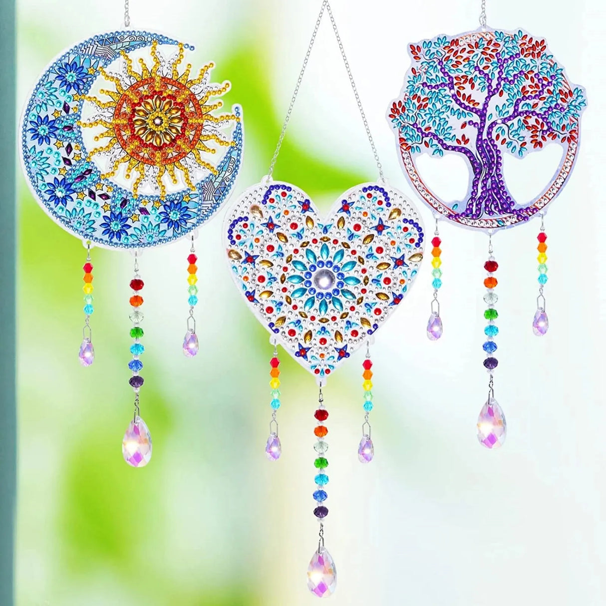 Decorative wall hangings with colorful patterns and beads on a blurred green background